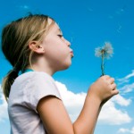 Children--Girl Blowing Flower