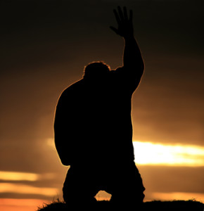 Misc--Man in prayer hand raised